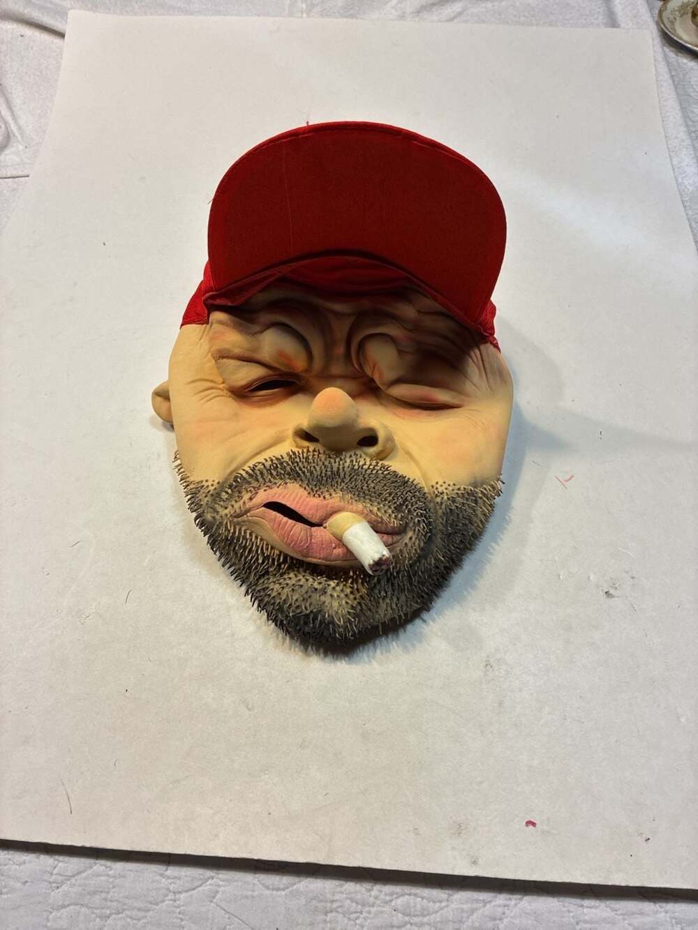 Realistic Man with Beard and Cigarette Latex Novelty Mask with Red Cap